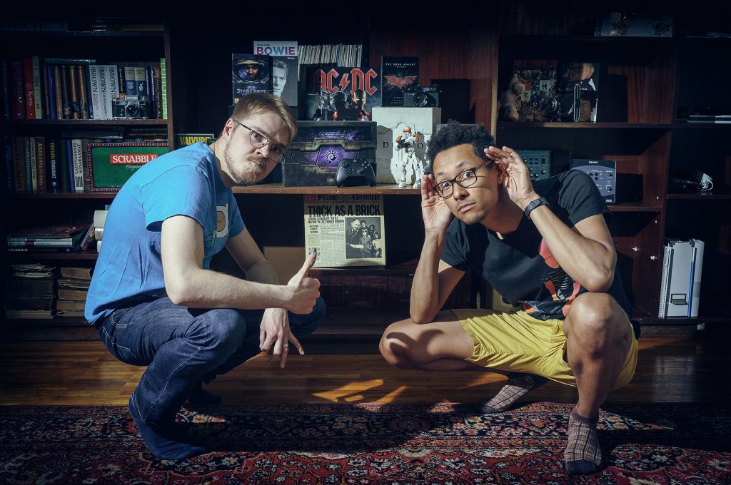 Ivo and Jim squatting in front of geeky things